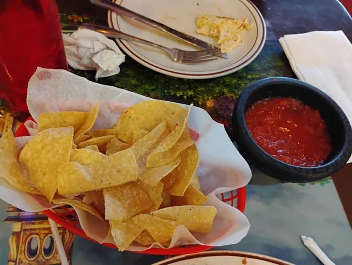 Chips, salsa, and drinks on the table at Coco Loco